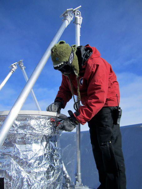 Graduate student Jonathan Kaufman placing a protective cover on top of the BICEP2 window's baffling in preparation for the installation of a 45 degree mirror for calibrations.